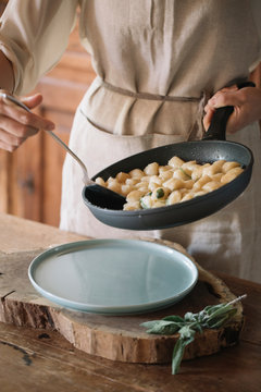 Potato gnocchi in frying pan being served