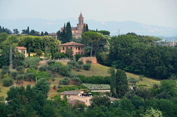 Fototapeta na wymiar Views of the Tuscan countryside with historic buildings, View of historic buildings in Italy with cypress trees, Tuscany, landscape, outlook, nature, green, hiking, trees, environment, italy, houses, 