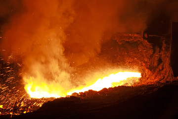 hot molten iron flowing from blast furnace