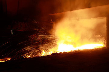 hot molten iron flowing from blast furnace