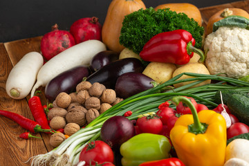Vegetables and nuts on a brown wooden background