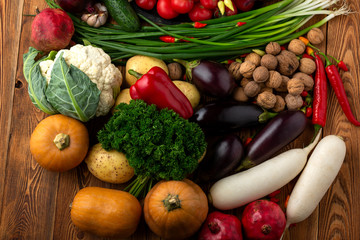 Vegetables and nuts on a brown wooden background