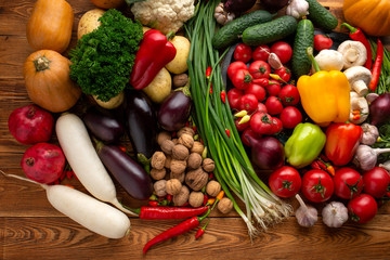 Vegetables and nuts on a brown wooden background