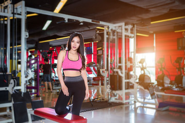 Fototapeta na wymiar Fitness Asian women Stand in sport gym interior and fitness health club with sports exercise equipment Gym background.