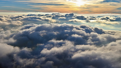 Above the clouds, paragliding in the autumn light of the November sun. Aerial perspective view of a...