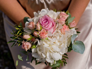 Obraz na płótnie Canvas Bridal bouquet in hand. Top view. Close-up.
