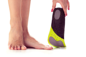 female feet and orthopedic insole