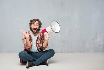 young crazy mad man  fool pose with a megaphone. announcement co