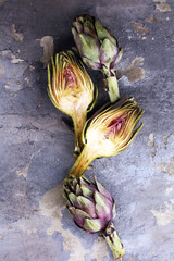 artichokes on grey background. fresh organic artichoke flower.