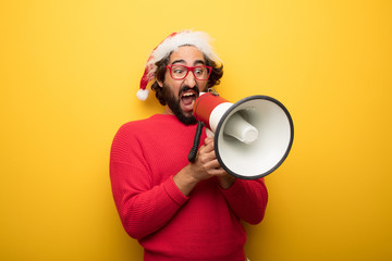 young crazy bearded man wearing red glasses and santa claus hat - obrazy, fototapety, plakaty