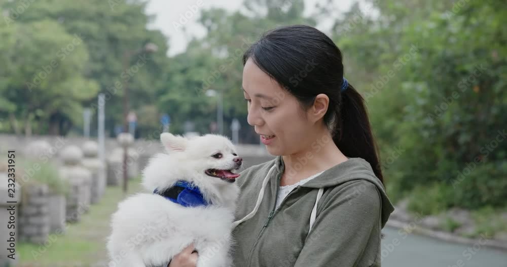 Canvas Prints Woman play with Pomeranian dog at outdoor park