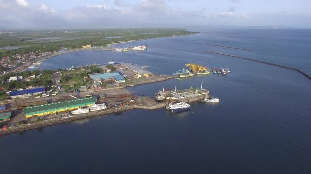 Dalahican, Lucena City, Philippines - December 28, 2017: View of fishing port and dock yard where boats are anchored side by side. Drone Aerial