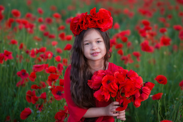 Amazing close up portrait of lovely cute young romantic girl with poppy flower in hand posing on field background. Wearing red stylish vamp dress or bouquet of flowers. Soft colors. Girl power