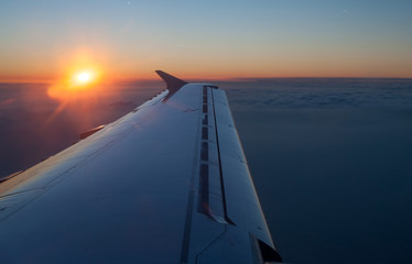 Aircraft jet wing with sunset