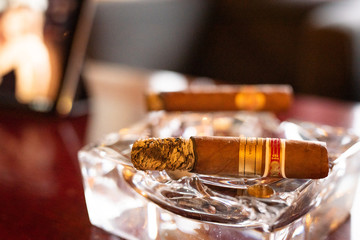 Two cigars on a crystal ashtray