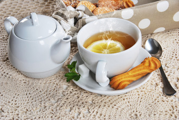 Delicious light breakfast in white ceramics with light tea with cookies