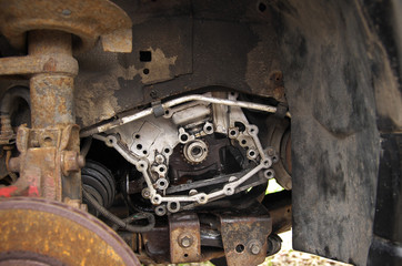 Fototapeta na wymiar engine, absorber and rusty brake disc on a broken car in the yard
