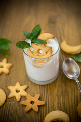 sweet homemade yogurt with cookies in a glass cup