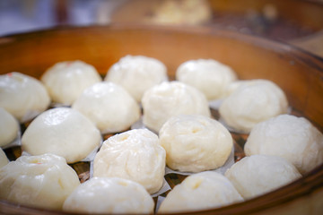 Fototapeta na wymiar Hot asian steam buns in steaming bamboo.