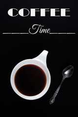 Obraz na płótnie Canvas White cup of coffee on a black background with the text 