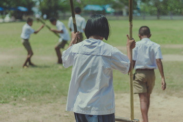 Student try to  walk on the Bamboo legs,Children playing Old tha
