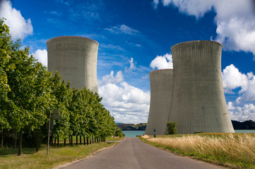 Atomic power plant with lake behind and blue sky.