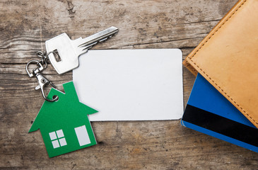 wallet and key on wood background