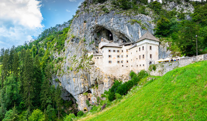 Predjama castle, Slovenia. Scenic view of Predjama castle near Postojna cave mouth. Anciend architecture builded in the rock. Old medieval fortress at sunny summer day.