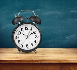 Blue retro alarm clock on wooden table