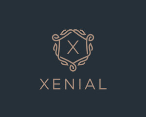Premium linear shield monogram letter X logotype. Elegant crest leaf stamp icon vector logo. Luxury alphabet frame symbol.