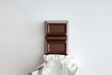 Obraz premium Chocolate bar on a light background.
