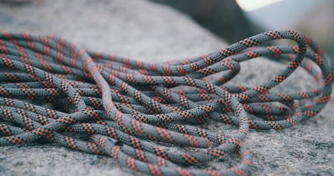 Coiled Climbing Rope Laying Idle On Desert Rock