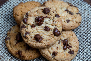  delicious cookie with chocolate drops, over wooden table and rustic tin.