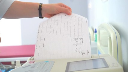 Doctor prints on the ECG printer. 1920X1080 Full Hd.	 - Powered by Adobe