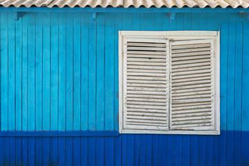 blue wooden wall with window