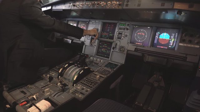 The cockpit of the aircraft. The pilot checks the electronics of the aircraft. Preparation of a passenger airliner for takeoff. The pilot checks the plane for flight. 4k