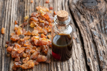A bottle of myrrh essential oil with myrrh resin crystals