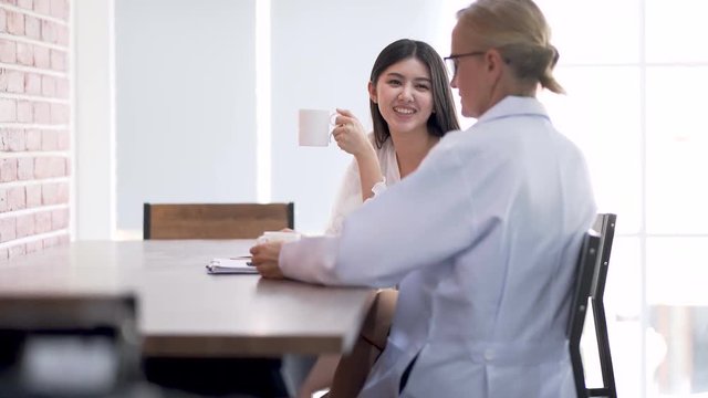 Senior female doctor smiling and relax talking something with a patient