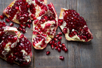 juicy red fruit pomegranate on wooden background