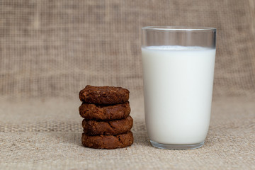  Photograph of a glass of milk with homemade cookies. American type cookie, tasty and very beautiful.