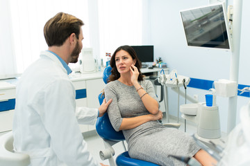 Fototapeta premium young beautiful woman at the dentist office. Dentist and his female patient in the dental clinic.