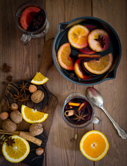 Mulled wine in glass pan with wine near at white background