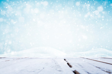 Winter background, falling snow over wooden deck 