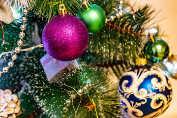 Festive Christmas composition, decorations on the Christmas tree, gift boxes, packaging and tinsel and silver beads. Toys and decorations for new year's eve. Various cones, balls, coasters and lantern