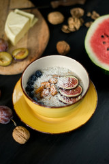 Fototapeta na wymiar Oatmeal porridge on the yellow plate blackberry