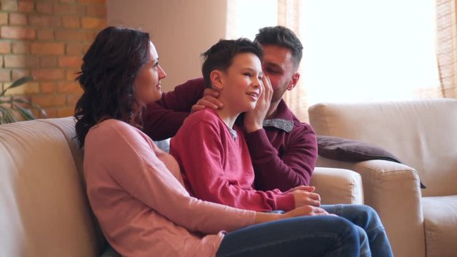 Family sharing secret into each others ear