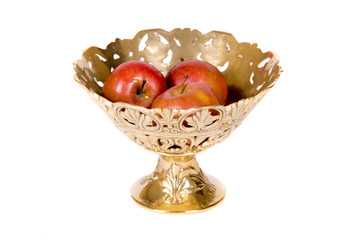 Golden vase with apples on white background