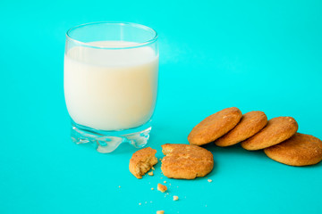 milk and biscuit on blue background. side view.