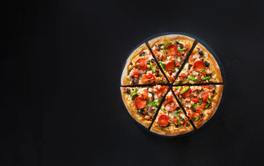 Flat lay of italian pizza on dark surface top view