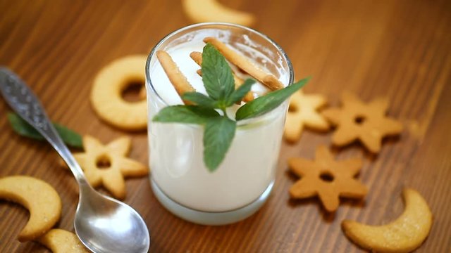 sweet homemade yogurt with cookies in a glass cup